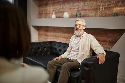 Happy Bearded Middled-aged Man Receiving Counselling